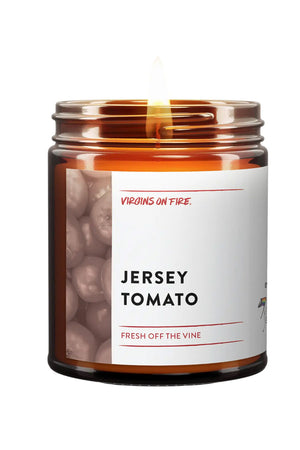 Amber glass candle jar with white label. The label says Jersey Tomato and features a black and white photo of tomatoes. White background.