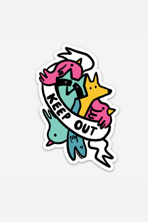 A die-cut sticker of pink and teal birds, a blue fish, a yellow wolf, and a teal raccoon behind a white banner that reads "Keep Out" in black text. 