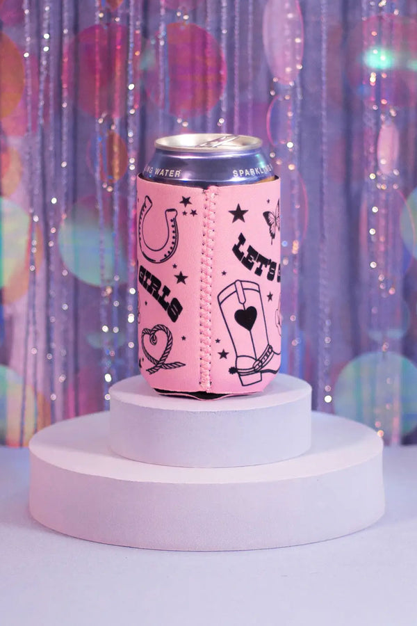 Side view of Pink koozie on a white circular platform. The koozie says Lets Go Girls in western font with cowboy boots, roses, ropes, horseshoe, butterfly, and stars surrounding the text. Purple glittery background.