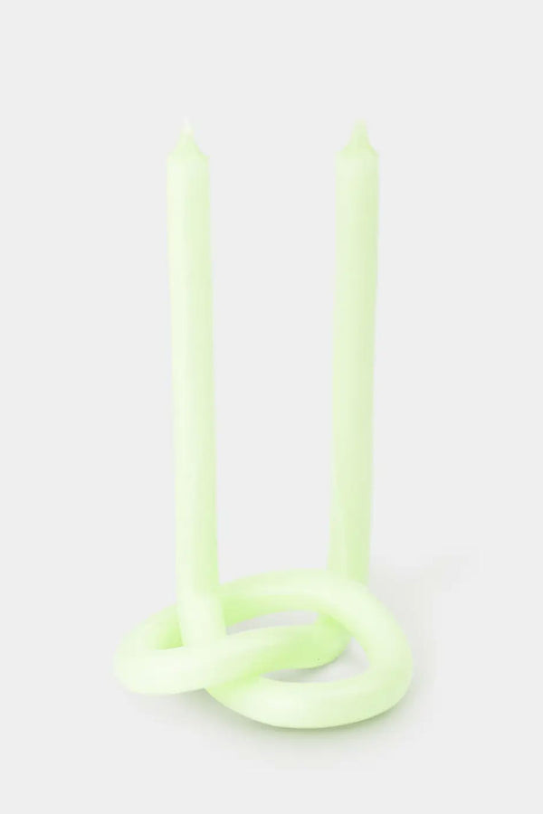 Twisted and knotted Candle with wicks at both ends. The candle color is light mint against a white background.