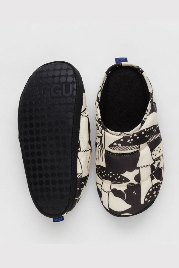 Puffy nylon, black fleece lined slippers with a white and brown mushroom pattern on a white background. 