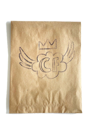 A brown kraft paper bag with a stamped Culture Flock logo.
