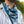 Load image into Gallery viewer, A person wearing a striped button up shirt outside with a navy bandana around their neck. The bandana features octopus tentacles and nautical rope around the border. 
