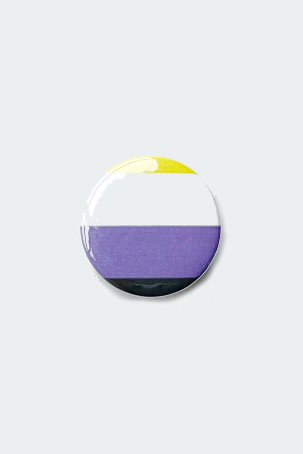 NonBinary Flag button on a white background. The flag design is four stripes, starting with yellow at the top, followed by white, purple, and black. 