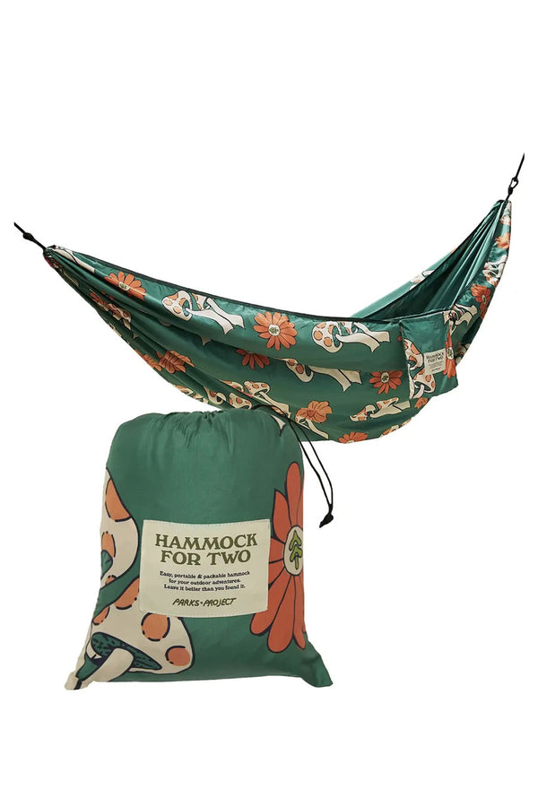 Two person hammock. The design is a green hammock with white and orange mushroom and flowers printed all over it. The hammock includes a matching pack that says "Hammock for Two".