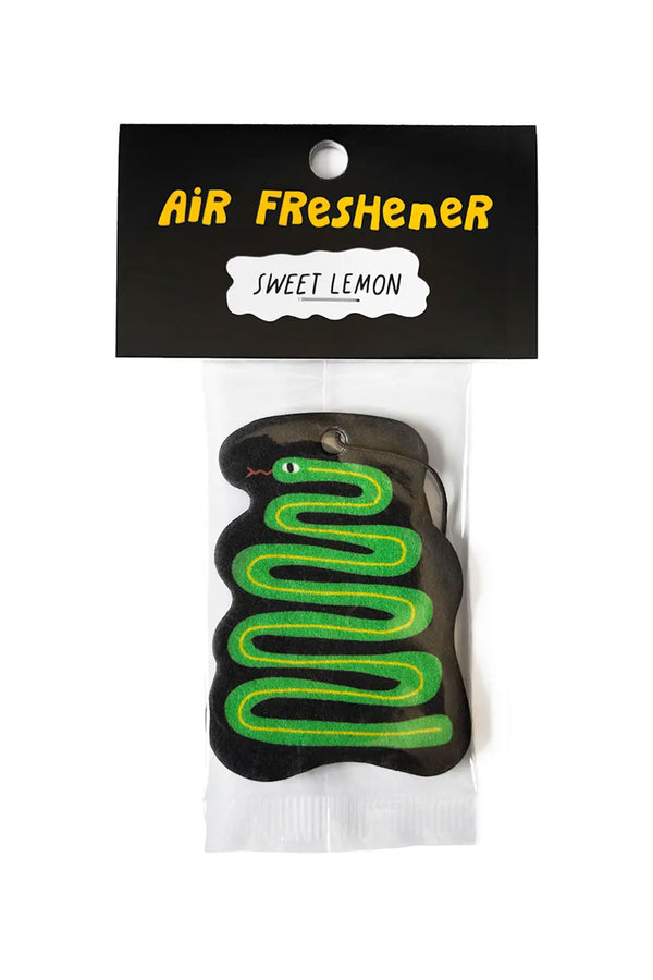 Illustrated air freshener of a green snake on a black background with a black elastic band at the top. Packaged in a clear bag with a black bag topper that says "Air Freshener" in yellow bubble letters. Underneath that in a white bubble in black text it says "Sweet Lemon".