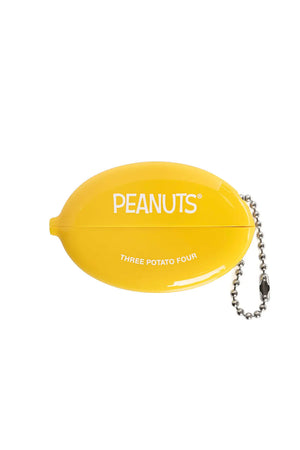 The back of a yellow plastic coin pouch with silver link chain.  One side of the pouch says Peanutes and below that it says Three Potato Four in white text. White backdground.