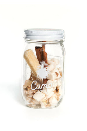 Clear Mason jar filled with cocktail ingredients. The ingredients are Ginger Root, Vegan Marshmallows, Whole Cinnamon, and Citrus Infused Non-GMO Vegan Sugar stick